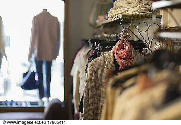 Clothes hanging on racks in boutique