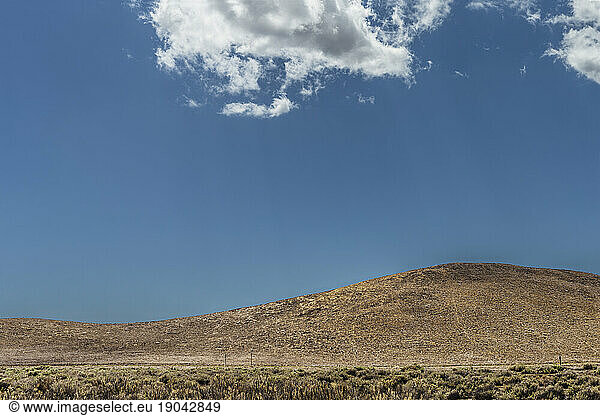 Cloud and a small hill with in the The Carrizo Plain.