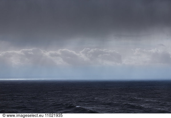 Clouds and rain over ocean seascape