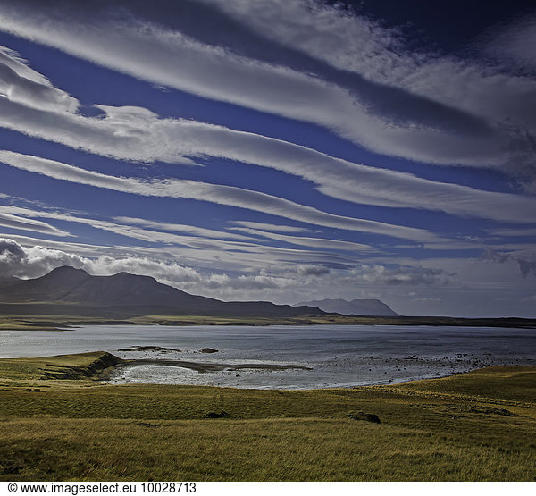 Clouds forming lines over lake and mountain landscape  Snaefellsnes  Iceland