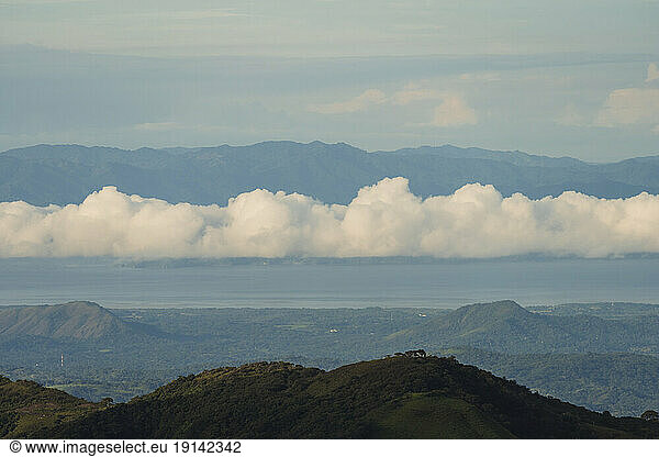 Clouds in sky over mountain ranges