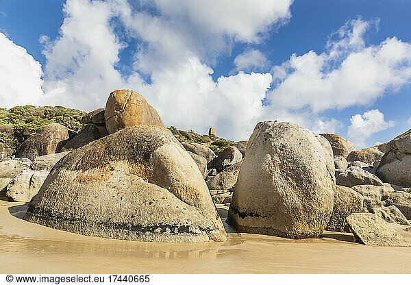 Clouds over boulders on sandy coastal beach in summer  Australia