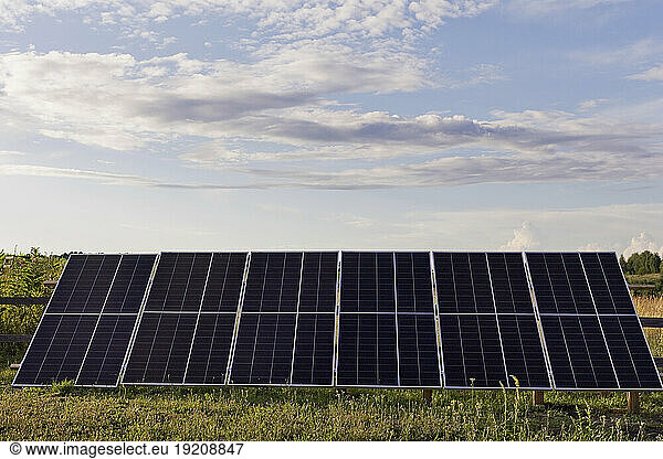 Clouds over solar panels standing outdoors