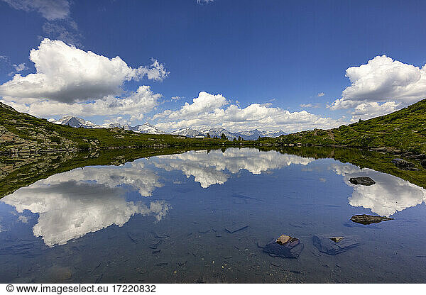 Clouds reflecting in small shiny lake in Speikboden massif