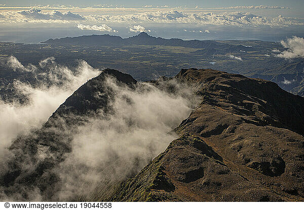 Clouds swirling around mountains of Kauai as seen from Helicopter
