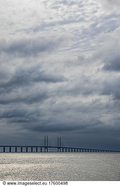 Cloudy sky over Sound strait with silhouette ofÂ OresundÂ Bridge in background