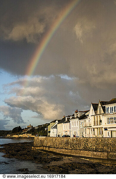 Cloudy sky with rainbow over Saint Mawes  Cornwall  UK.