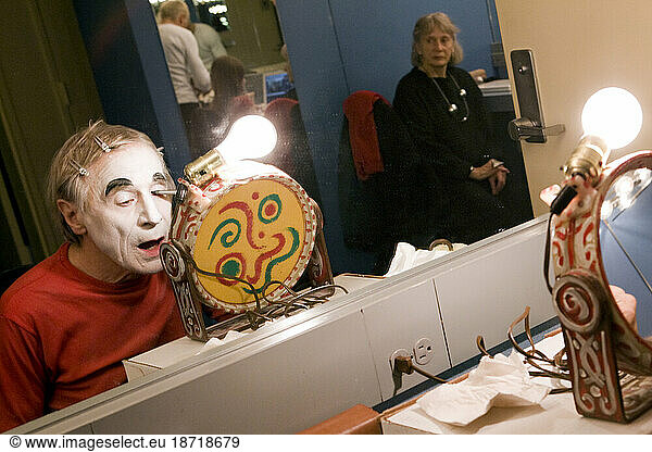Clown Dimitri applying theater make-up backstage