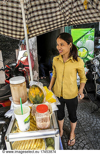Clutching Money From A Sale  Saigon Street Food Vendor Appears Happy
