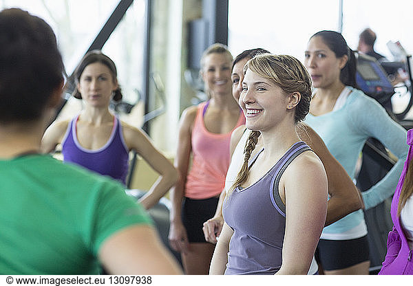 Coach instructing women in gym