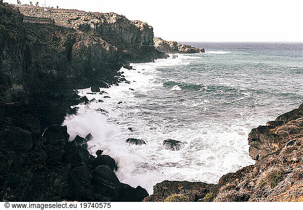 Coastal cliffs with waves breaking over rocks