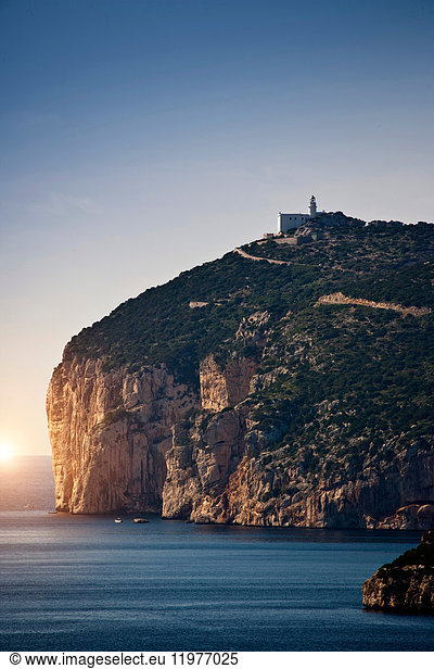 Coastal view with cliff top lighthouse  Capo Caccia  Alghero  Sardinia  Italy