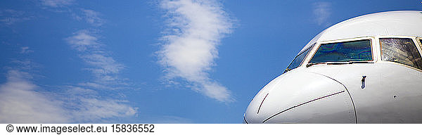 Cockpit of jet airplane against blue skies