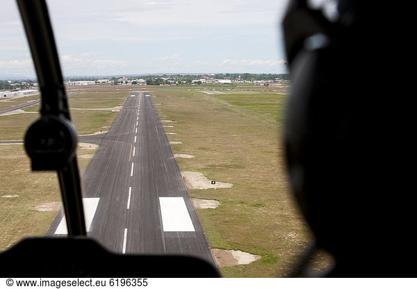 Cockpit view of airplane landing on airport runway