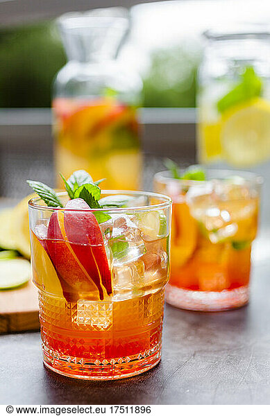 Cocktail with peach  mint and lime and ice cubes