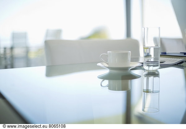 Coffee cup and water glass on meeting table
