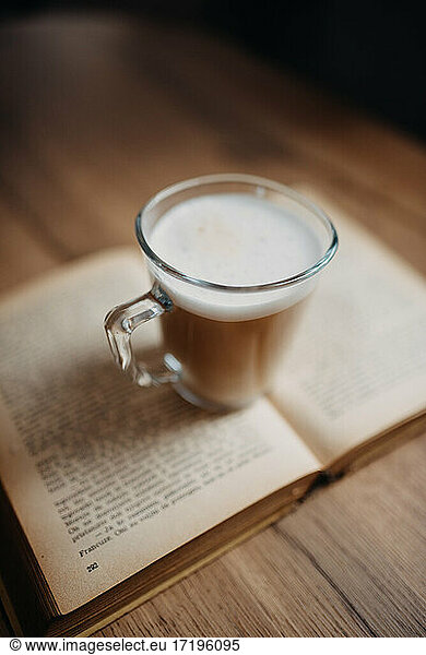Coffee on old book closeup.