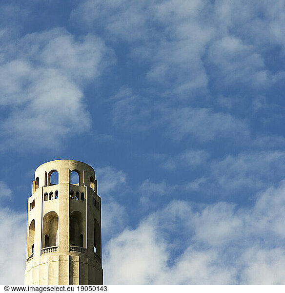 Coit Tower  San Francisco  CA. against blue cloudy sky.