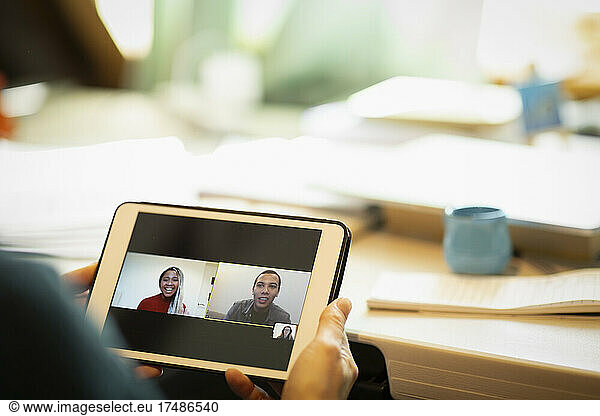 Colleagues video chatting on digital tablet screen