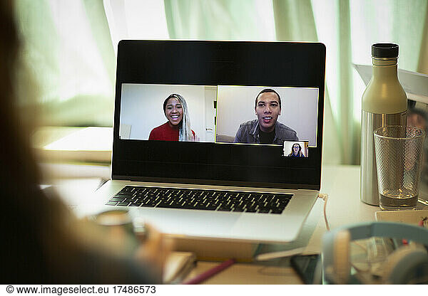 Colleagues video conferencing on laptop screen