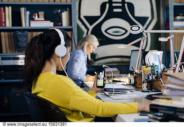 Colleagues working in architect's office  woman having conference call