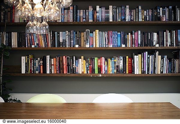 Coloful wall with many books on book shelves in a modern living room blurred  retro interior beauty.