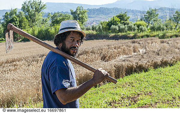 Colombian portrait with an orchard tool  copy space.