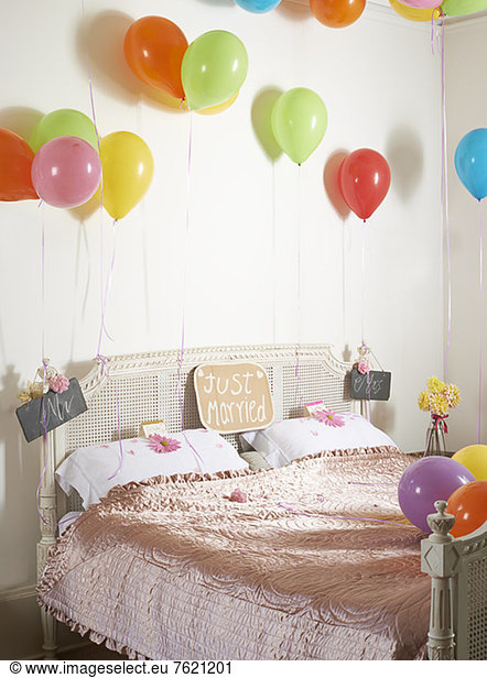 Colorful balloons over marriage bed