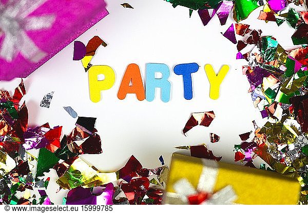Colorful confetti and presents with the word Party  decoration isolated on white background cheerful.