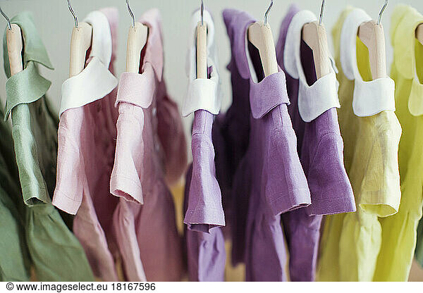 Colorful dresses hanging on rack