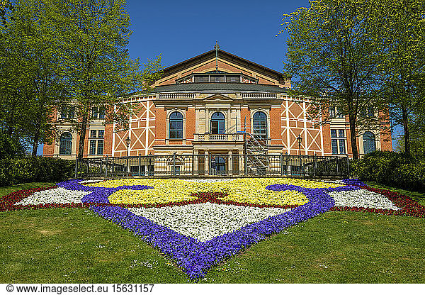 Colorful flowers in front of Bayreuth Festspielhaus during sunny day  Bayreuth  Germany