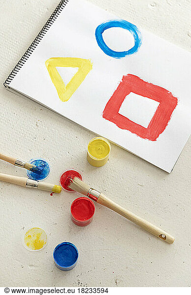 Colorful geometric shapes painted in note pad