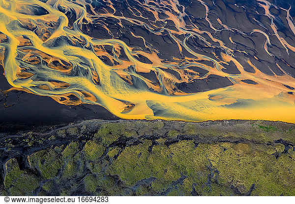Colorful glacier rivers on the south coast of Iceland with black sand