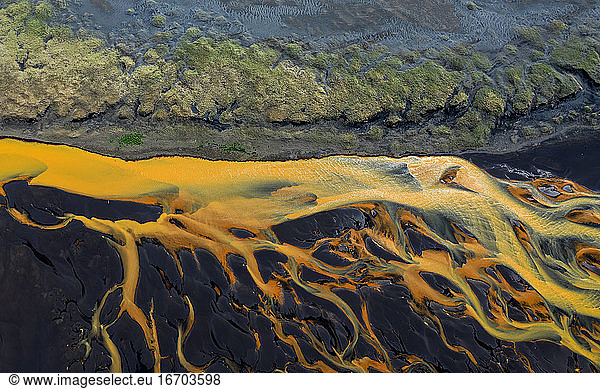 Colorful glacier rivers on the south coast of Iceland with black sand