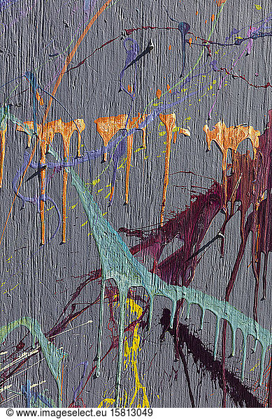 Colorful graffiti paint splattered and dripping on urban wall  close up