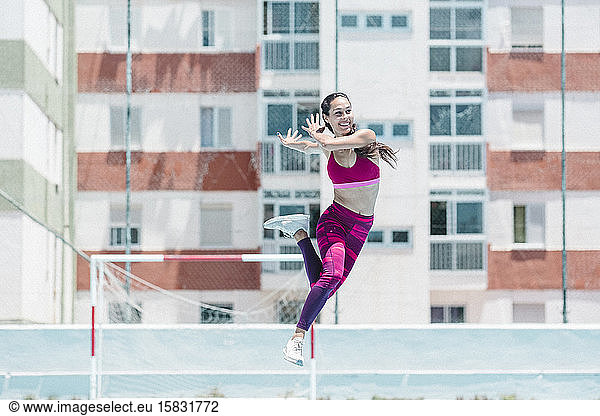 Colorful image of full body of female athlete jumping on court