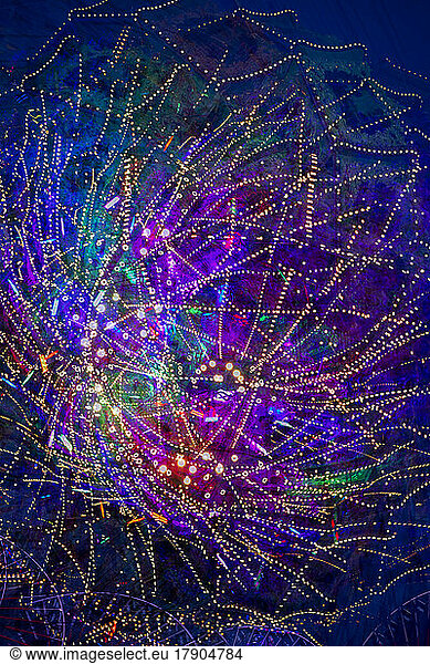 Colorful lights of spinning amusement park ride
