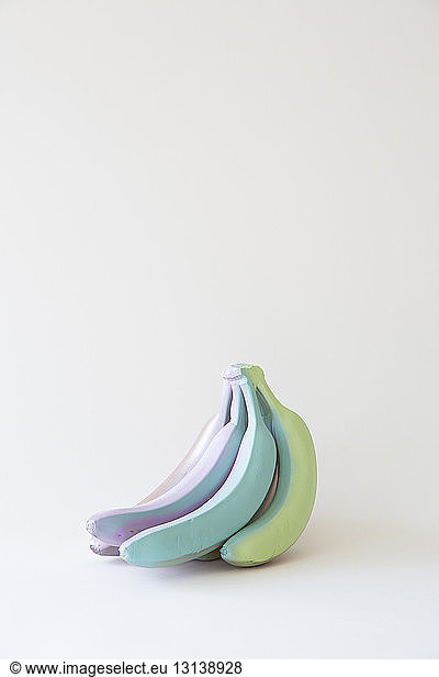 Colorful painted bananas on white background