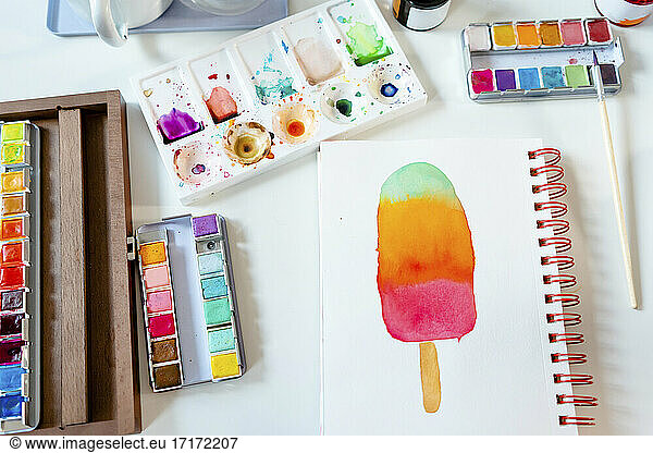 Colorful popsicle painted with watercolors on spiral notebook