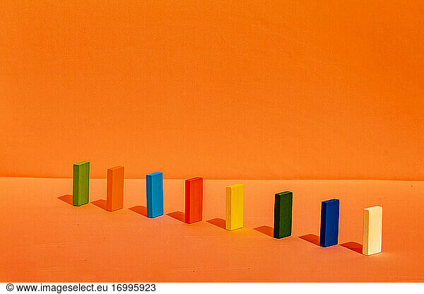 Colorful rectangular block arranged in a line on orange background