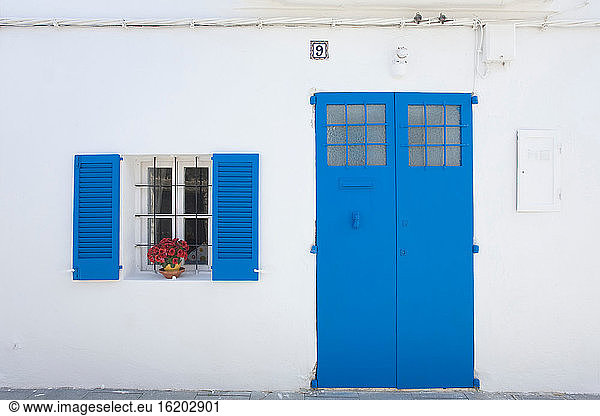 Colorful shutters and flowers on house
