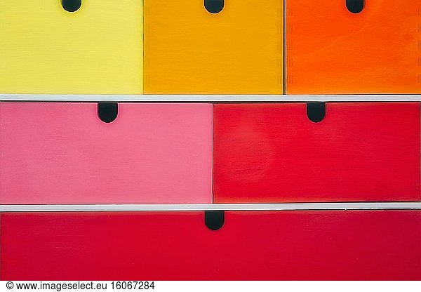 Colorful wooden drawers in various colors  modern interior background texture retro close-up.