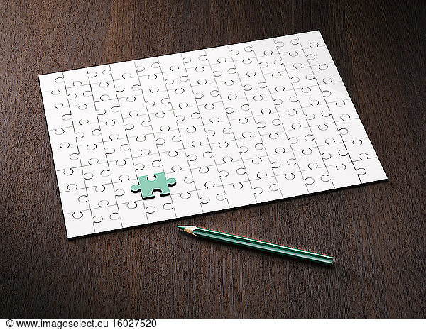 Coloring pencil by puzzle and green puzzle piece