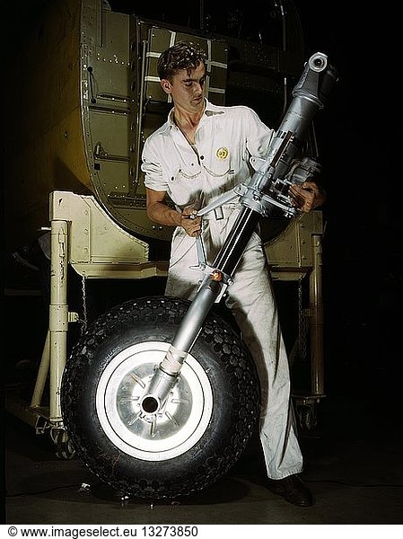 Colour photograph of a nose wheel and landing gear assembly for a B-25 bomber under construction in a western aircraft plant  North American Aviation  Inc.  Calif. Dated 1942