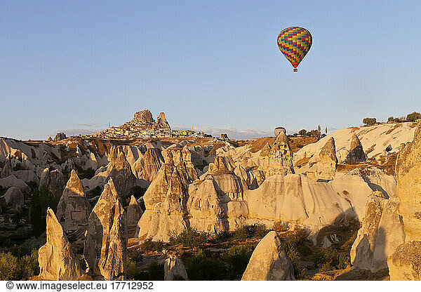 Colourful Hot Air Balloon Flying Over The Rugged Landscape; Cappodocia  Turkey
