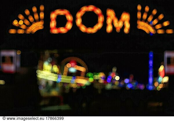 Colourful lights in the darkness  form the lettering Dom  entrance to Hamburg Cathedral in the evening  neon lights  bokeh  fair  public festival  funfair on the Heiligengeistfeld  St. Pauli  Hamburg  Germany  Europe