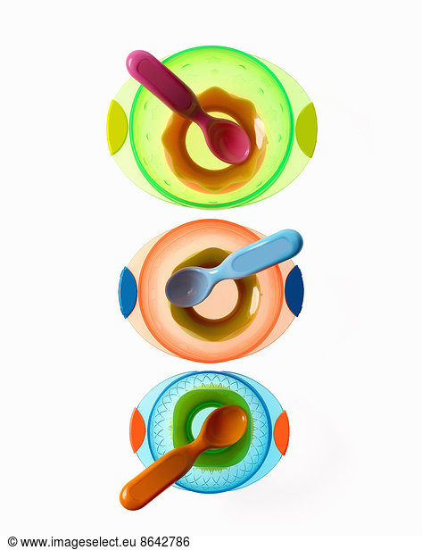 Colourful plastic spoons for use by infants and babies. Coloured plastic bowls.