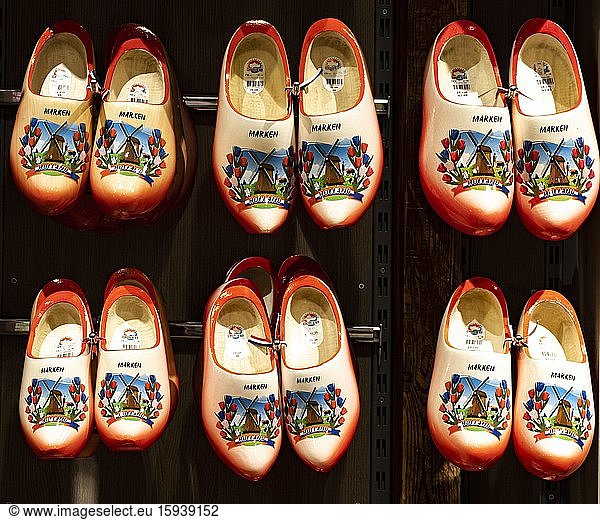 Colourfully painted traditional Dutch wooden shoes hanging on a wooden wall  Volendam  North Holland  Netherlands