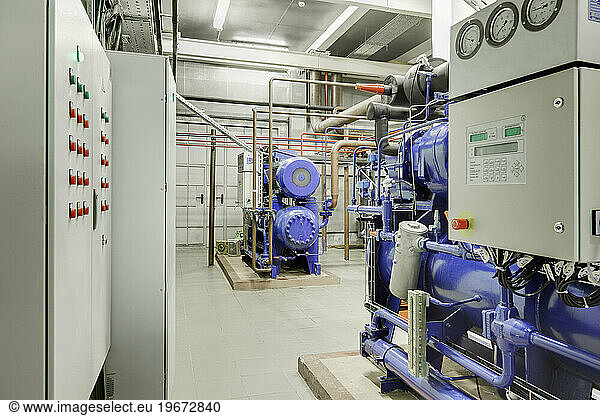 Compressor station in an ice rink  machinery used for rink ice cooling. Machine room with pipes and cooling equipment.
