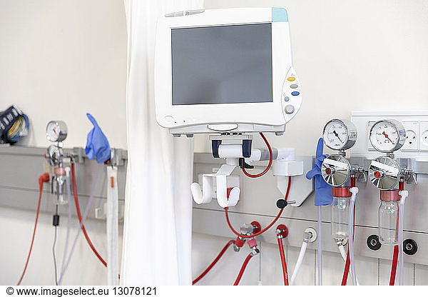 Computer monitor with medical equipment against wall in hospital